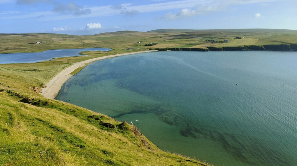 A golden sand beach stretches into the distance in Tresta on Fetlar