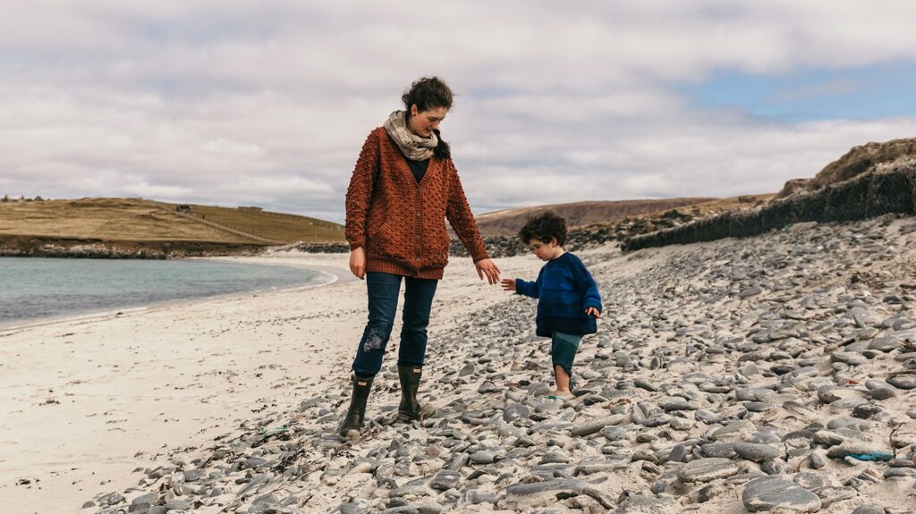 Family walking along the beach in Shetland