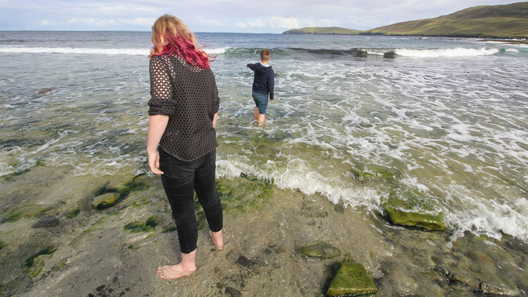 Paddling at Saviskaill Beach in Rousay, Orkney