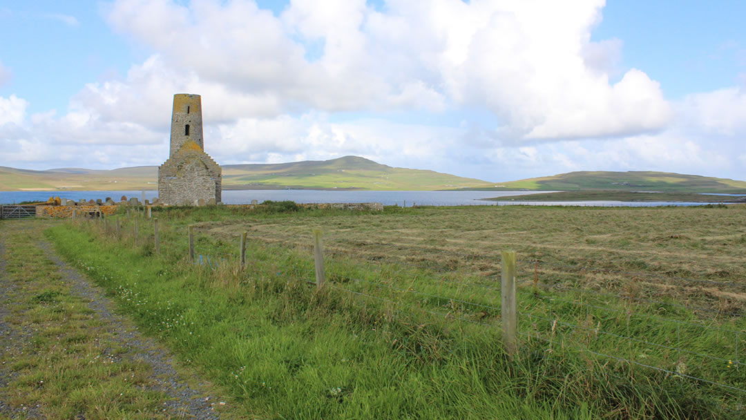 St Magnus Church with the hills of Rousay in the distance
