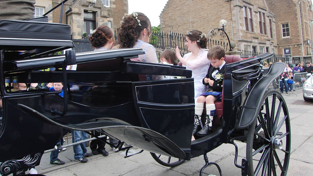 The Stromness Shopping Week Queen and attendants arrive at Stromness Pier Head