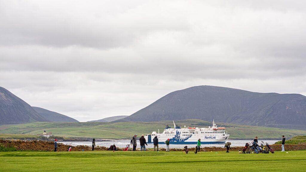 The MV Hamnavoe sailing past Stromness Golf Club