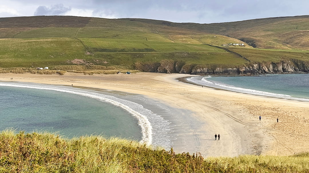 Walkers on St Ninian's Beach